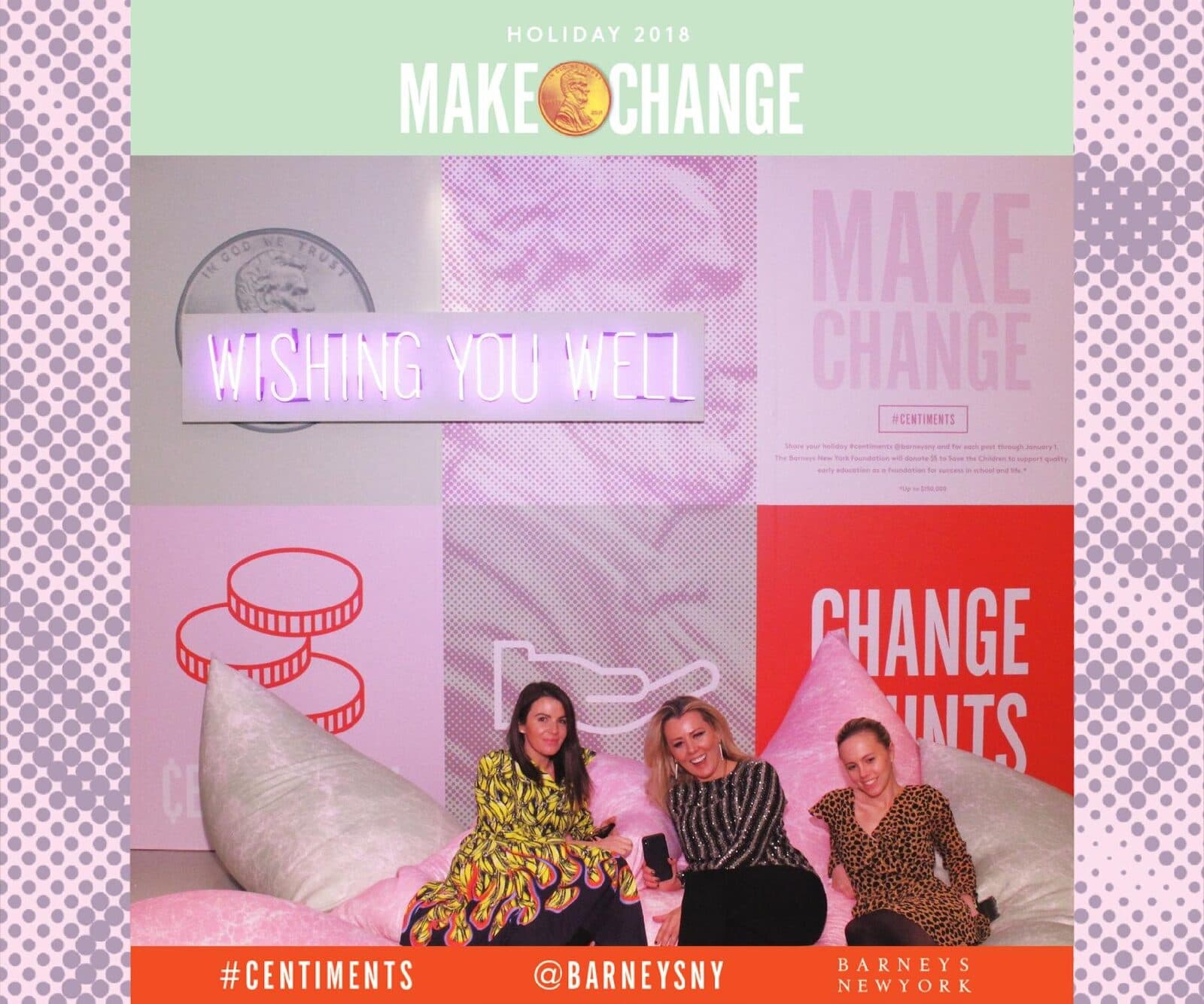 Guests posing together on the pillows in front of the Barneys “Make Change” holiday set.